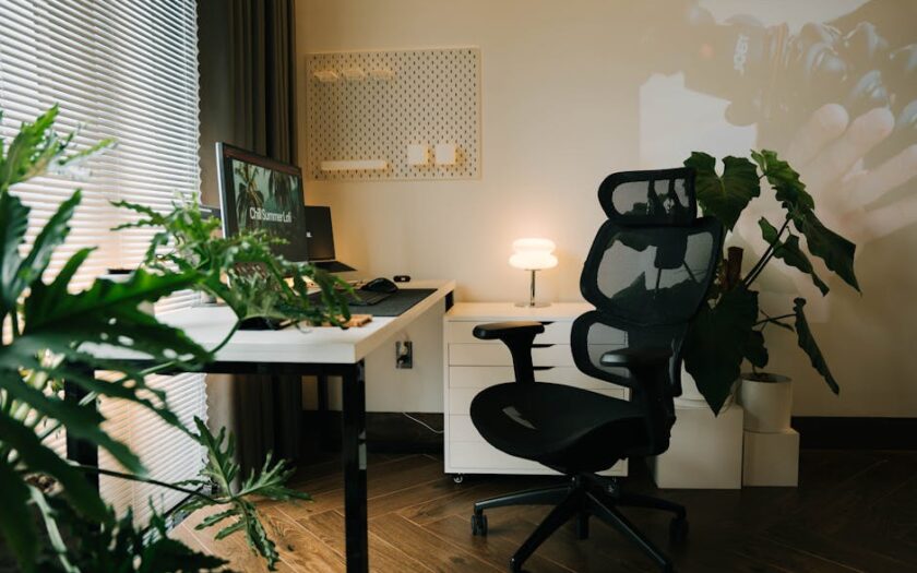 Cozy and modern home office setup with a stylish ergonomic chair, plants, and a desktop monitor. - Photo by Alpha En on Pexels