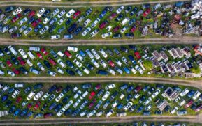 Top view of a busy scrapyard in Saint Charles filled with rows of abandoned vehicles and metal parts. - Photo by Tom Fisk on Pexels