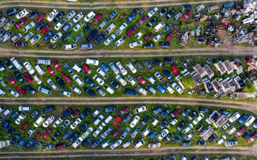 Top view of a busy scrapyard in Saint Charles filled with rows of abandoned vehicles and metal parts. - Photo by Tom Fisk on Pexels