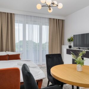 A bright modern studio apartment features a cozy living area with elegant decor. - Photo by Mateusz Pielech on Pexels