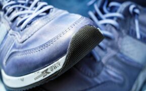 Detailed view of blue athletic sneakers showcasing mesh textures and laces. - Photo by Pixabay on Pexels