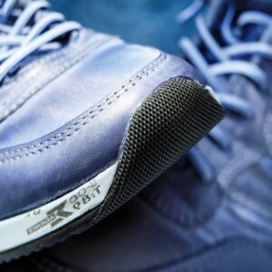 Detailed view of blue athletic sneakers showcasing mesh textures and laces. - Photo by Pixabay on Pexels
